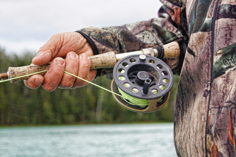 Fisherman holding fly rod